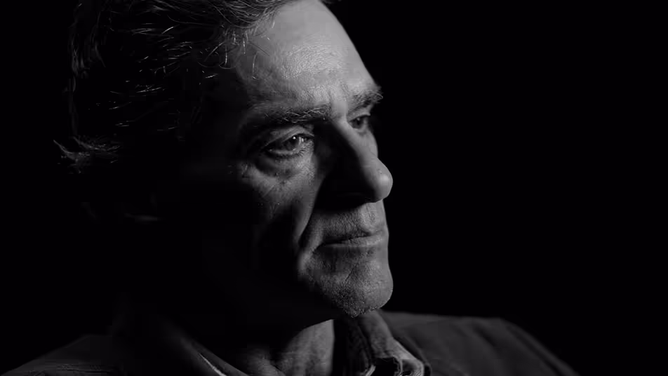 A picture of Scott in front of a black background